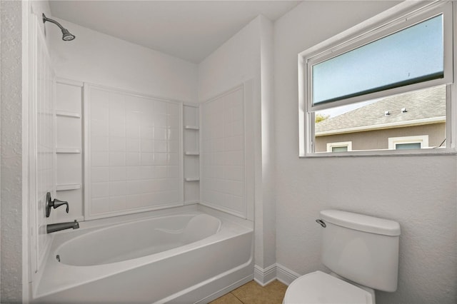 bathroom with shower / tub combination, toilet, and tile floors