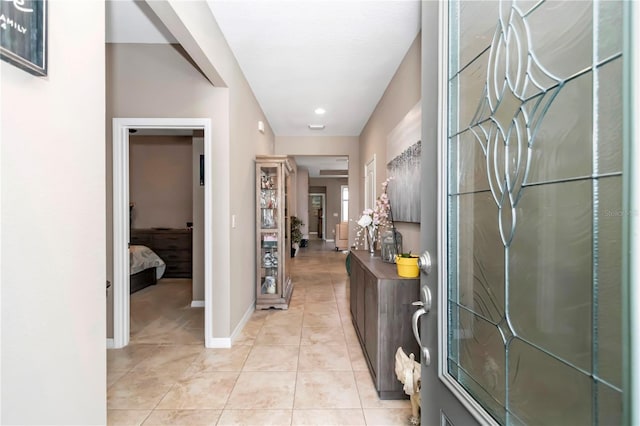 corridor featuring light tile flooring