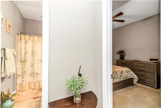 bedroom featuring light carpet and ceiling fan