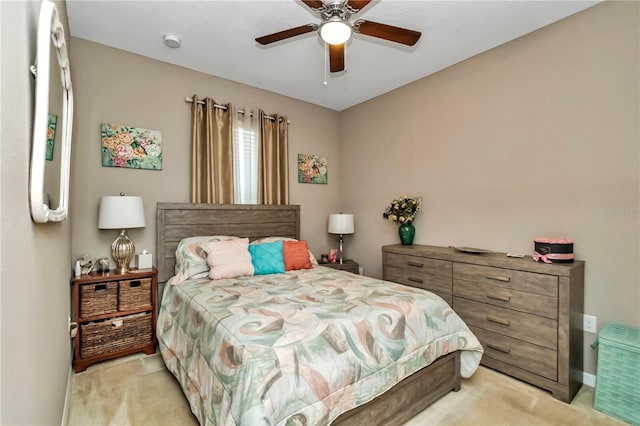 bedroom with light carpet and ceiling fan