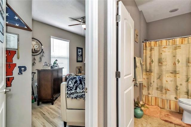 bathroom with toilet, tile floors, and ceiling fan