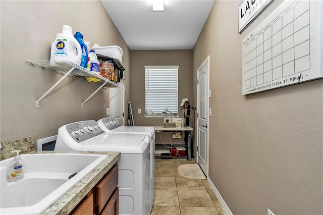 laundry room with sink, cabinets, independent washer and dryer, and light tile flooring