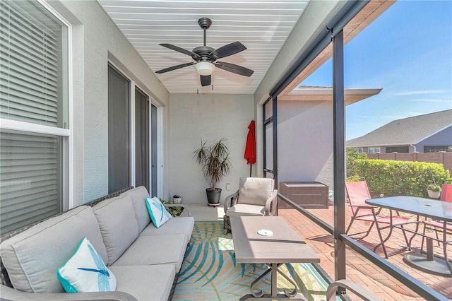 sunroom / solarium with plenty of natural light and ceiling fan