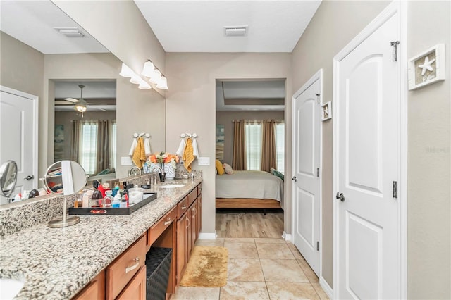 bathroom featuring tile floors, ceiling fan, and double sink vanity