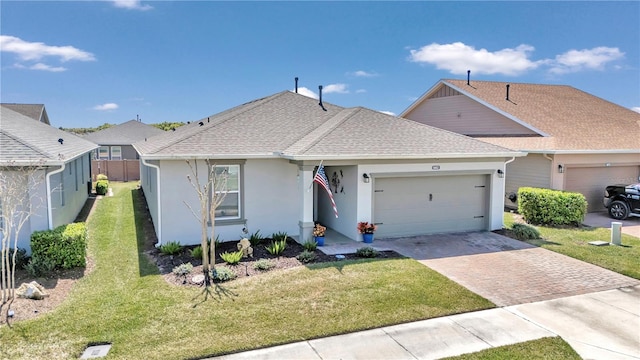 view of front of home featuring a front lawn and a garage