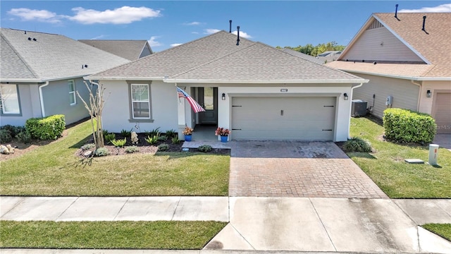 view of front facade featuring central AC, a front lawn, and a garage