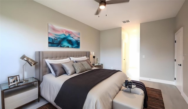 bedroom with dark hardwood / wood-style flooring and ceiling fan