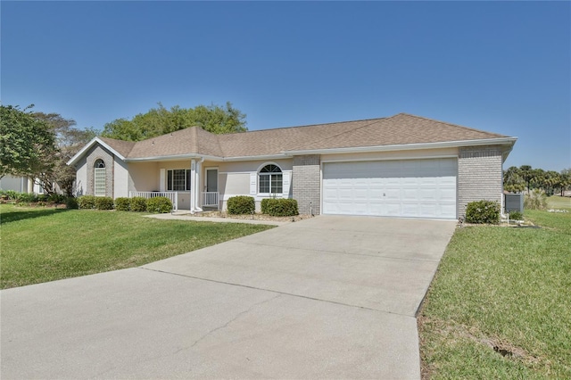 single story home with covered porch, a front yard, central AC unit, and a garage