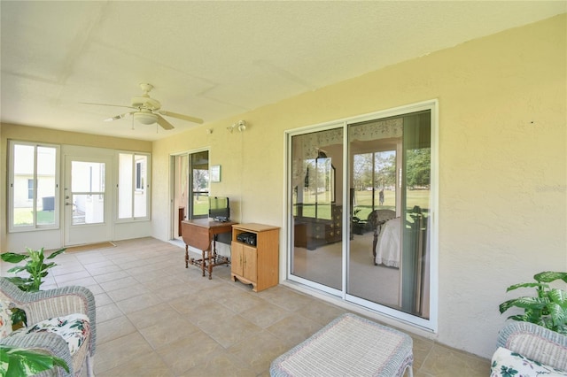 sunroom featuring ceiling fan