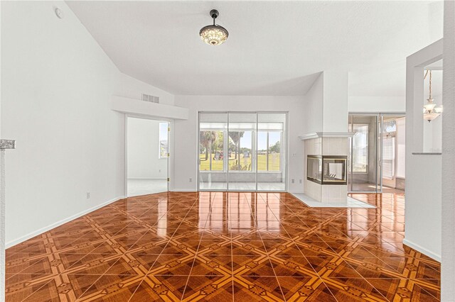 interior space featuring a tile fireplace and lofted ceiling