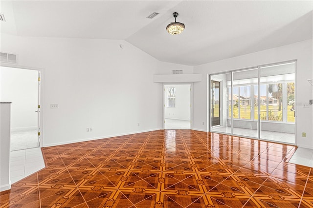 carpeted empty room featuring lofted ceiling