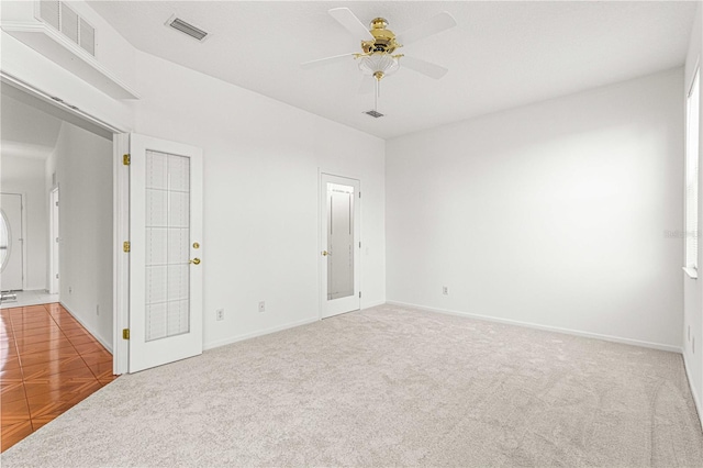 carpeted spare room with ceiling fan