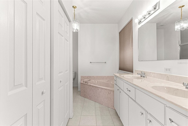 bathroom with toilet, dual sinks, vanity with extensive cabinet space, a bath, and tile floors