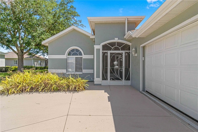 doorway to property with a garage