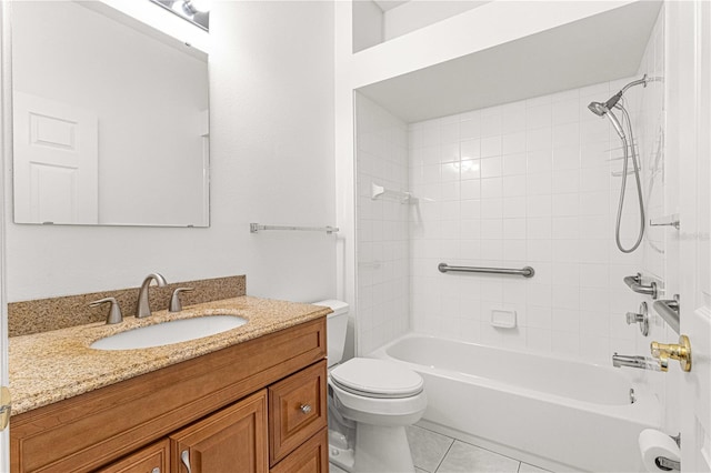 full bathroom featuring tile flooring, vanity, toilet, and tiled shower / bath