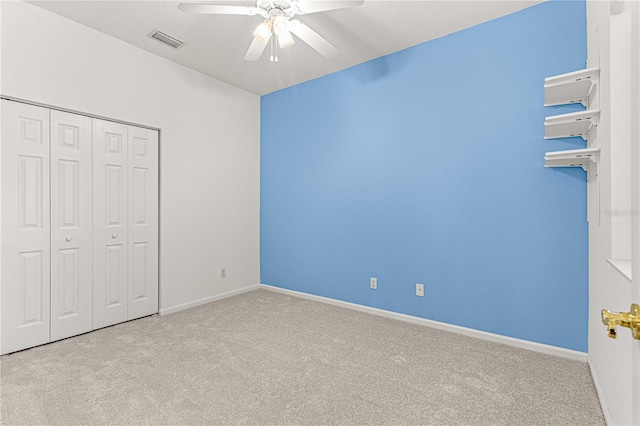 unfurnished bedroom featuring light colored carpet and ceiling fan