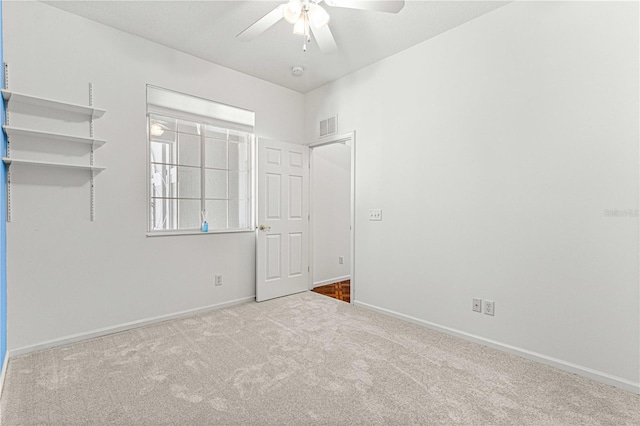 empty room featuring light colored carpet and ceiling fan