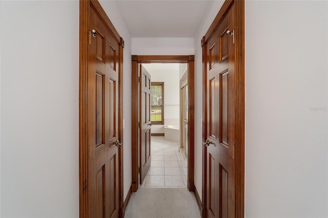 hall with light tile patterned floors