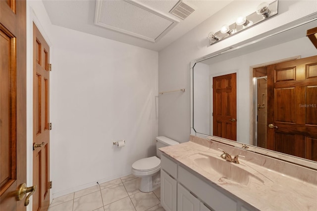 bathroom featuring tile patterned flooring, vanity, toilet, and a shower with door