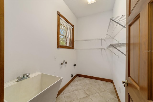 laundry area featuring light tile patterned flooring and washer hookup