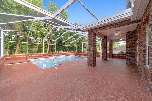 view of swimming pool featuring glass enclosure, ceiling fan, and a patio