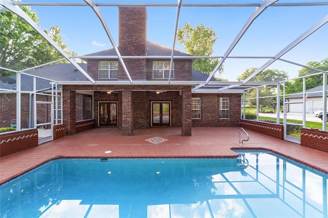 view of swimming pool with a lanai and a patio area