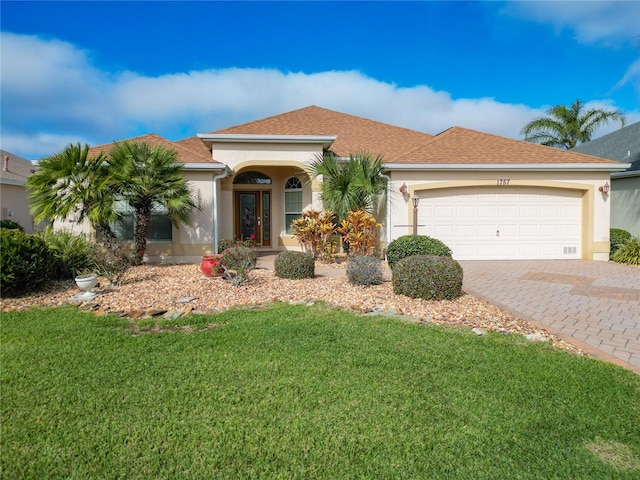 view of front of property with a garage and a front yard