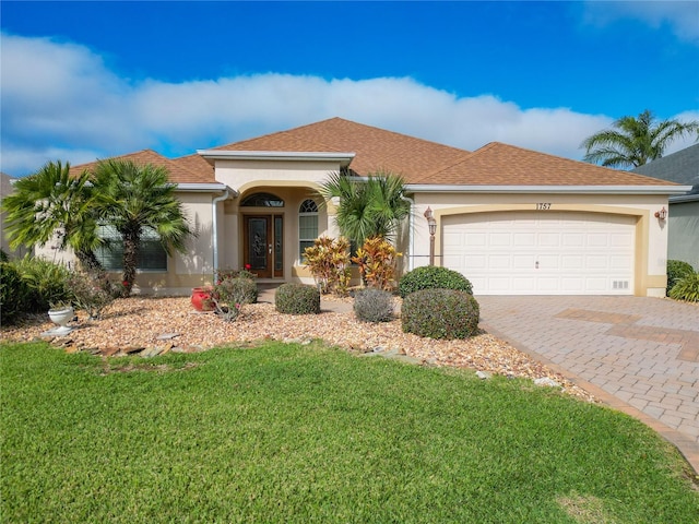 view of front facade with a garage and a front lawn