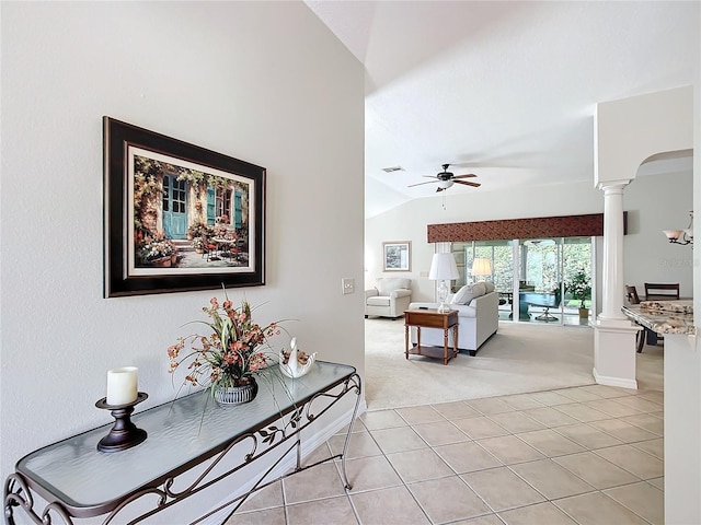 interior space with vaulted ceiling, light carpet, and decorative columns