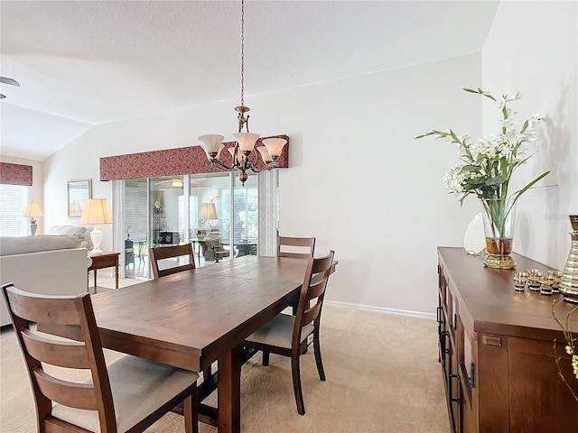 dining space with plenty of natural light, light colored carpet, lofted ceiling, and an inviting chandelier