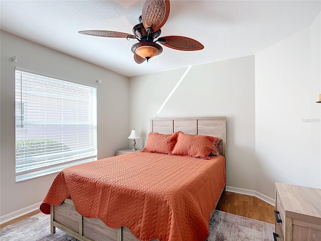 bedroom with ceiling fan and light hardwood / wood-style flooring