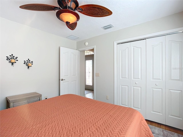 bedroom with a closet, ceiling fan, and hardwood / wood-style flooring