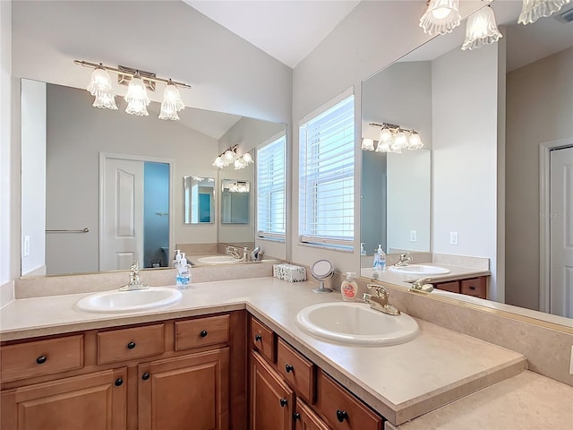 bathroom featuring vanity and lofted ceiling