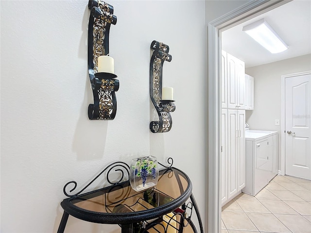 interior space with light tile patterned floors and separate washer and dryer