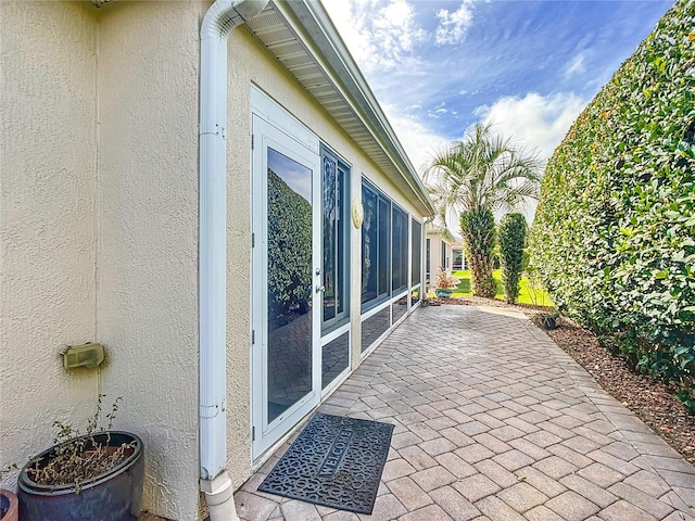 view of side of property featuring a patio area