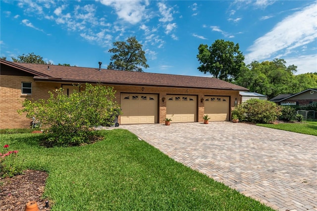 single story home with a front lawn and a garage