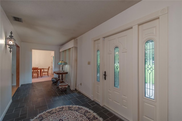 tiled entryway with a wealth of natural light