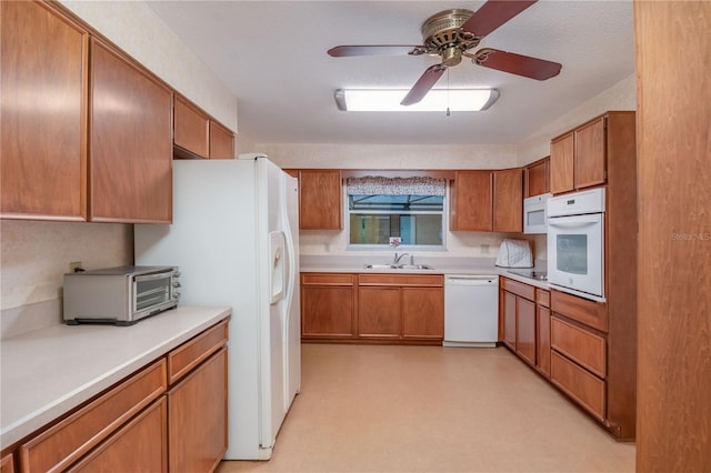 kitchen featuring ceiling fan, sink, white appliances, and a textured ceiling