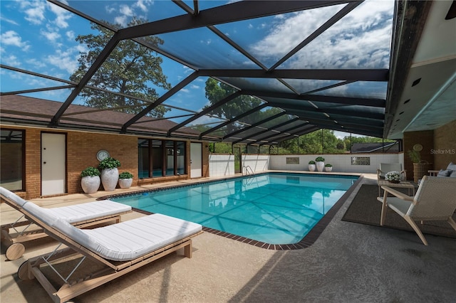 view of pool featuring a patio area and glass enclosure