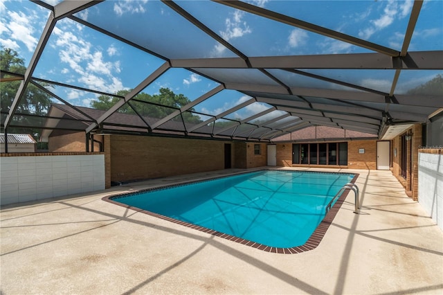 view of swimming pool with a lanai and a patio