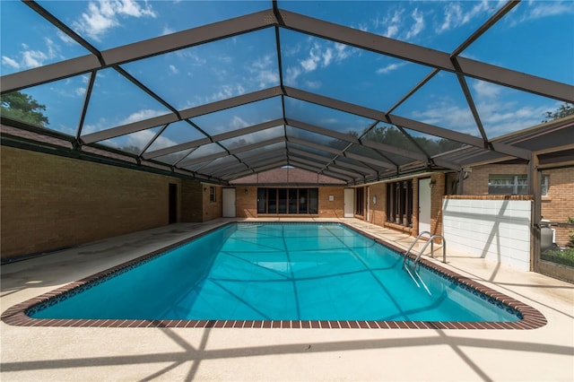 view of pool with a patio and a lanai