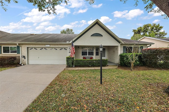 single story home with a front yard, a porch, and a garage