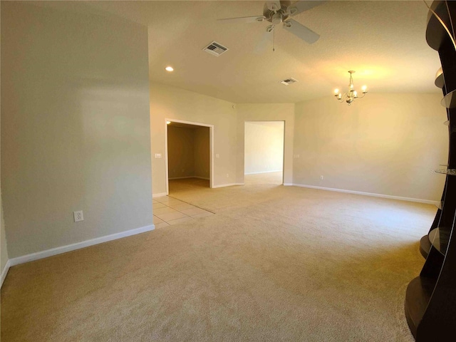 spare room with light colored carpet and ceiling fan with notable chandelier