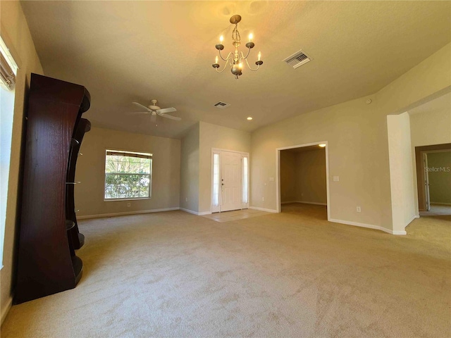 empty room featuring light carpet and ceiling fan with notable chandelier