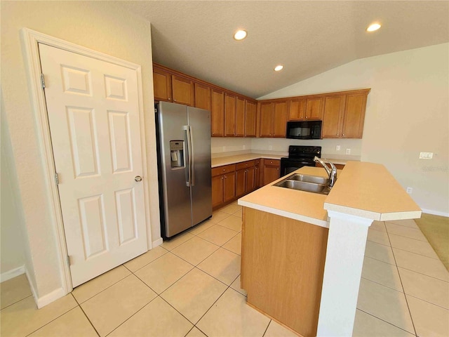 kitchen featuring lofted ceiling, black appliances, sink, light tile floors, and a center island with sink