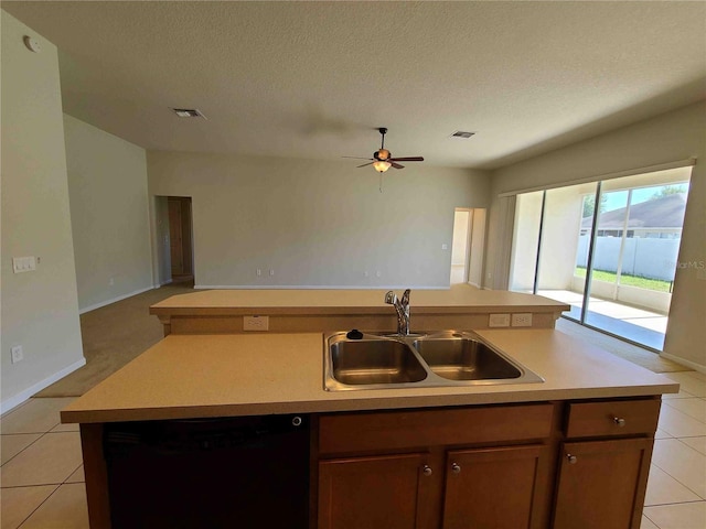 kitchen featuring light tile floors, ceiling fan, a center island with sink, dishwasher, and sink