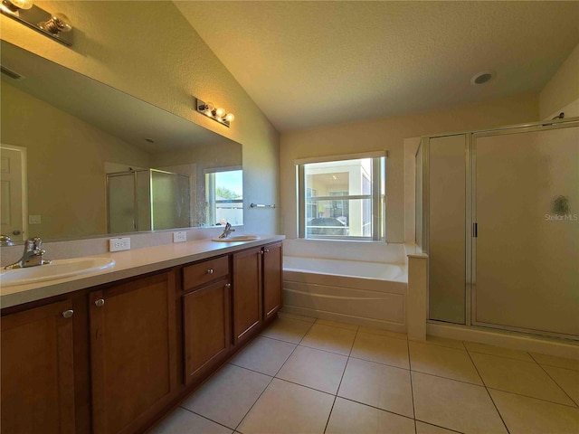 bathroom with large vanity, vaulted ceiling, double sink, separate shower and tub, and tile floors