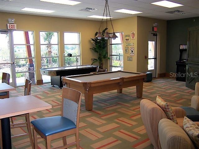 playroom featuring a paneled ceiling, billiards, and dark colored carpet