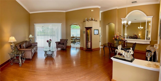 interior space featuring ornamental molding, a notable chandelier, and dark hardwood / wood-style flooring