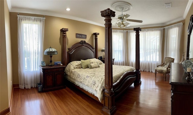 bedroom with dark hardwood / wood-style flooring, multiple windows, and ceiling fan